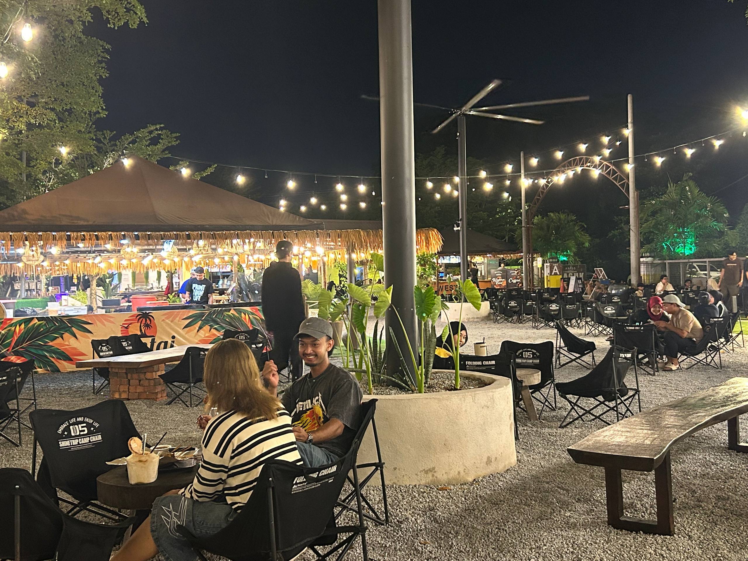 Open-air tables beneath strings of lights.