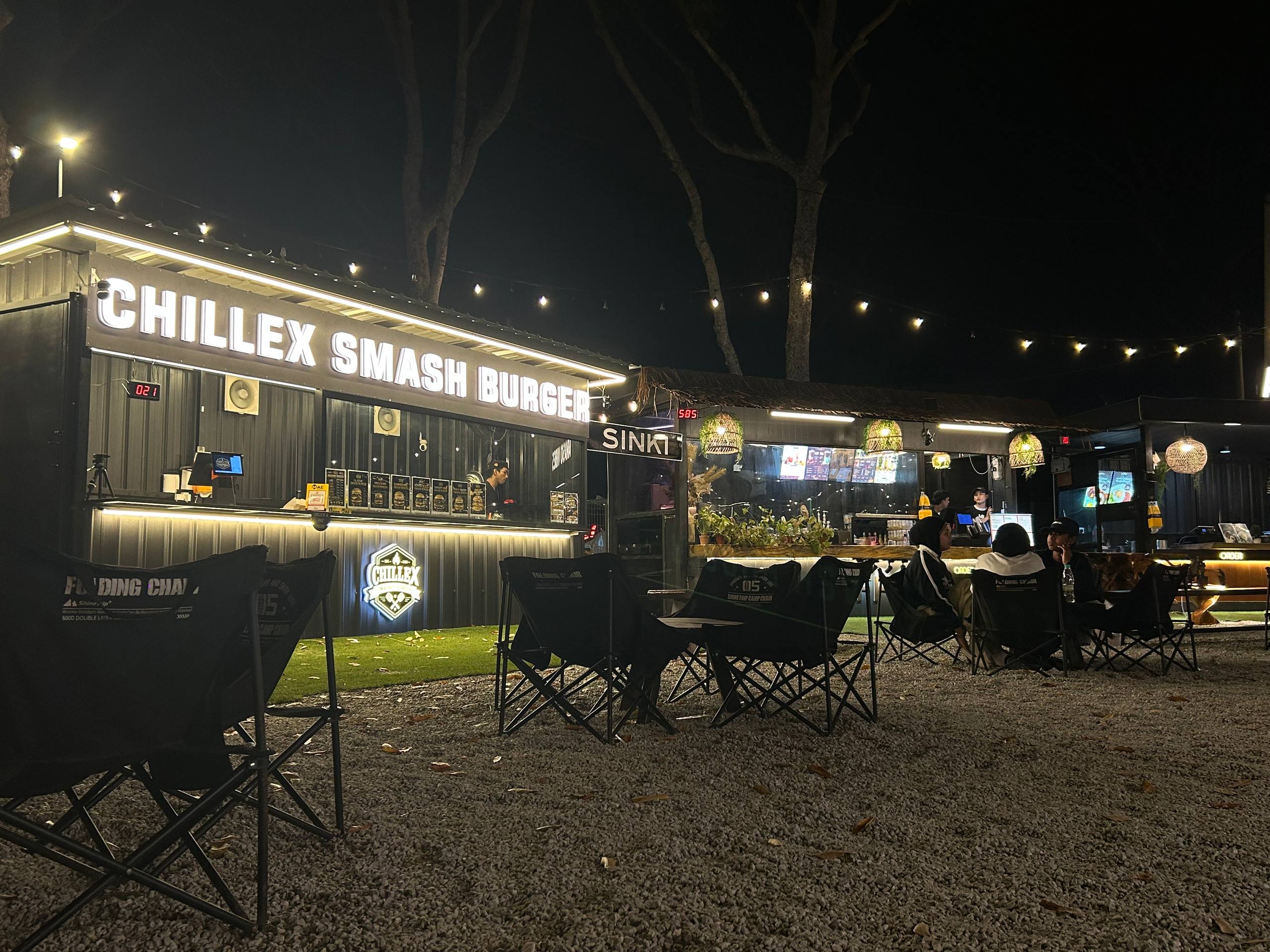 Illuminated food counters and open-air seating in the Araso courtyard